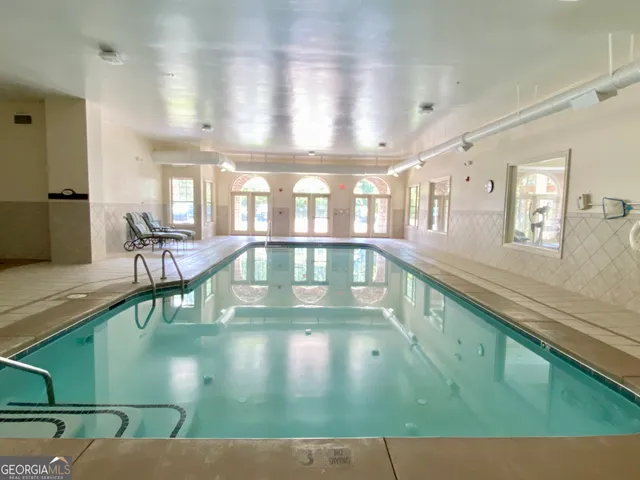 a view of a livingroom with wooden floor and furniture