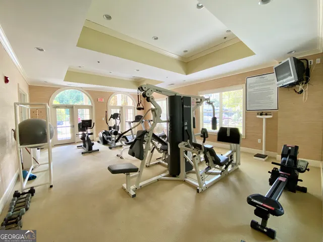 a room with gym equipment and large window