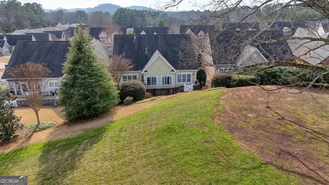 a view of a house with a big yard plants and large trees