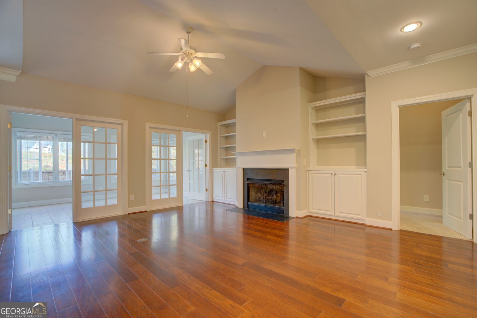 115 Carriage Way Southeast Rome, GA 30161 - Photo 8 of 39 an empty room with wooden floor fireplace and windows