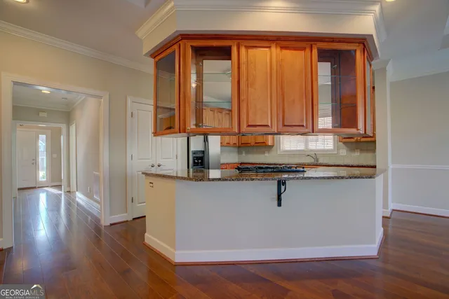 a kitchen with stainless steel appliances granite countertop a sink a stove and dishwasher with wooden floor