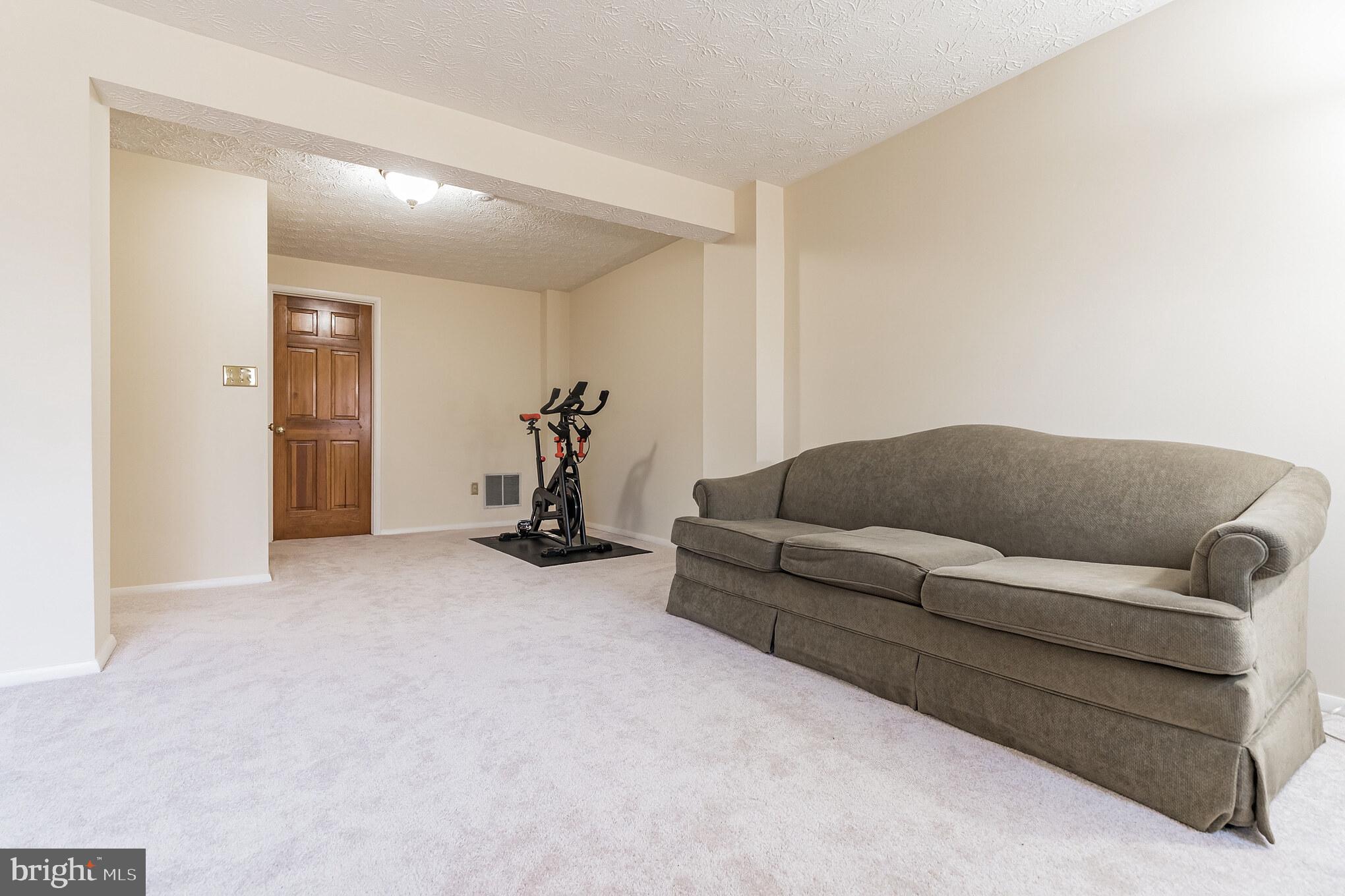 1610 Barnstead Drive Reston, VA 20194 - Photo 26 of 33 a living room with furniture and a flat screen tv