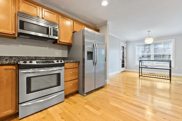 a kitchen with stainless steel appliances granite countertop a stove and a microwave