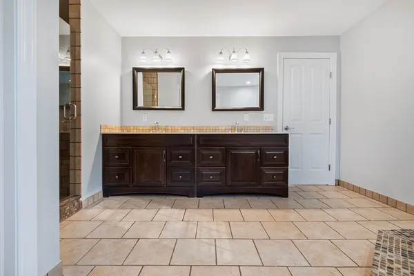 a spacious bathroom with a sink and a mirror
