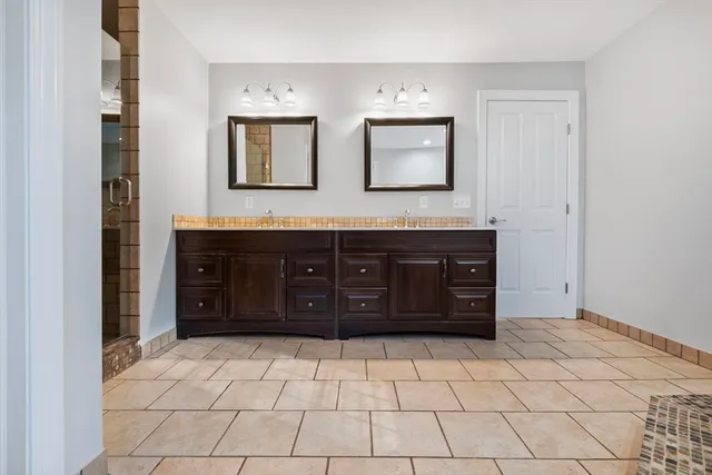 a spacious bathroom with a sink and a mirror