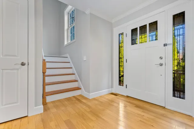 a view of an entryway with wooden floor