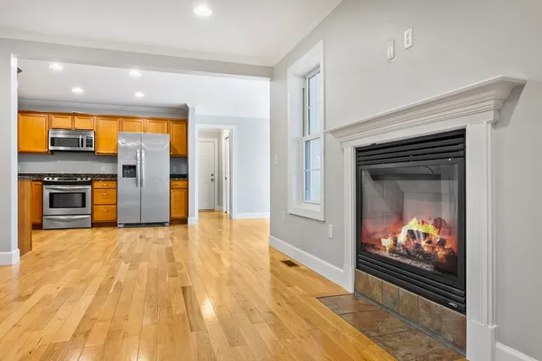a view of a kitchen with a sink and a fireplace