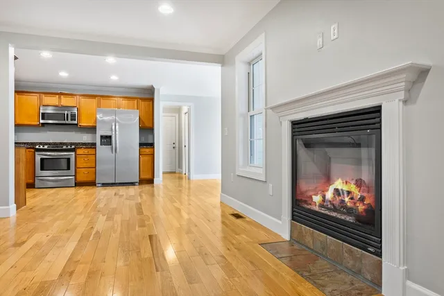 a view of a kitchen with a sink and a fireplace