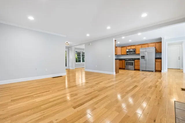a big room with wooden floor and a yard