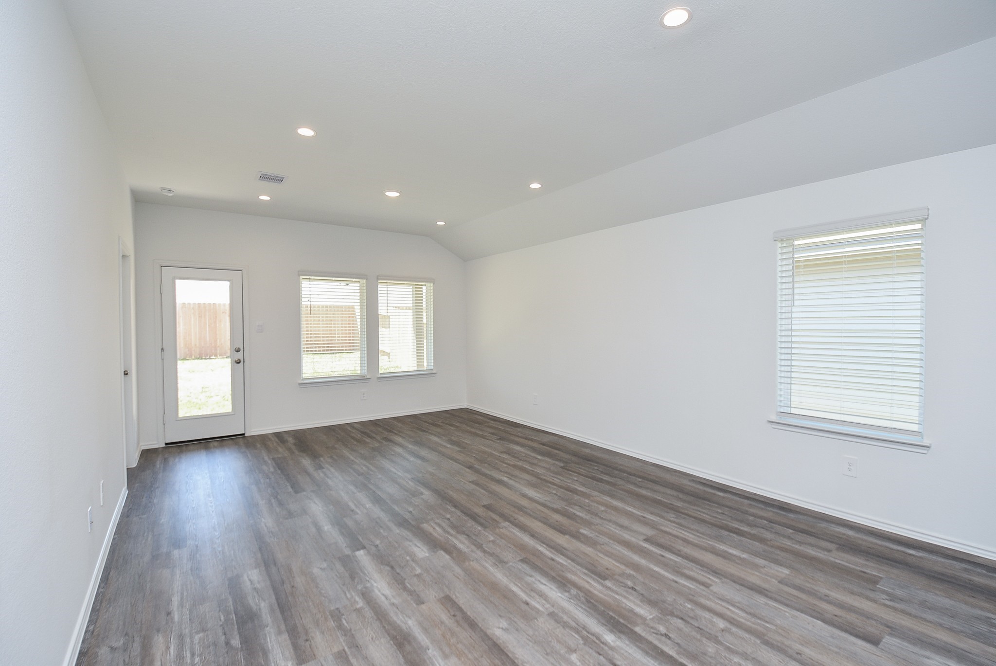 5735 Sycamore Glen Dr Spring Spring, TX 77373 - Photo 11 of 26 an empty room with wooden floor and windows