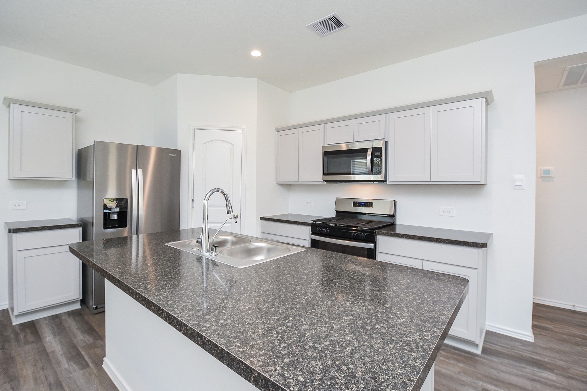 5735 Sycamore Glen Dr Spring Spring, TX 77373 - Photo 4 of 26 a kitchen with granite countertop a refrigerator stove top oven and sink