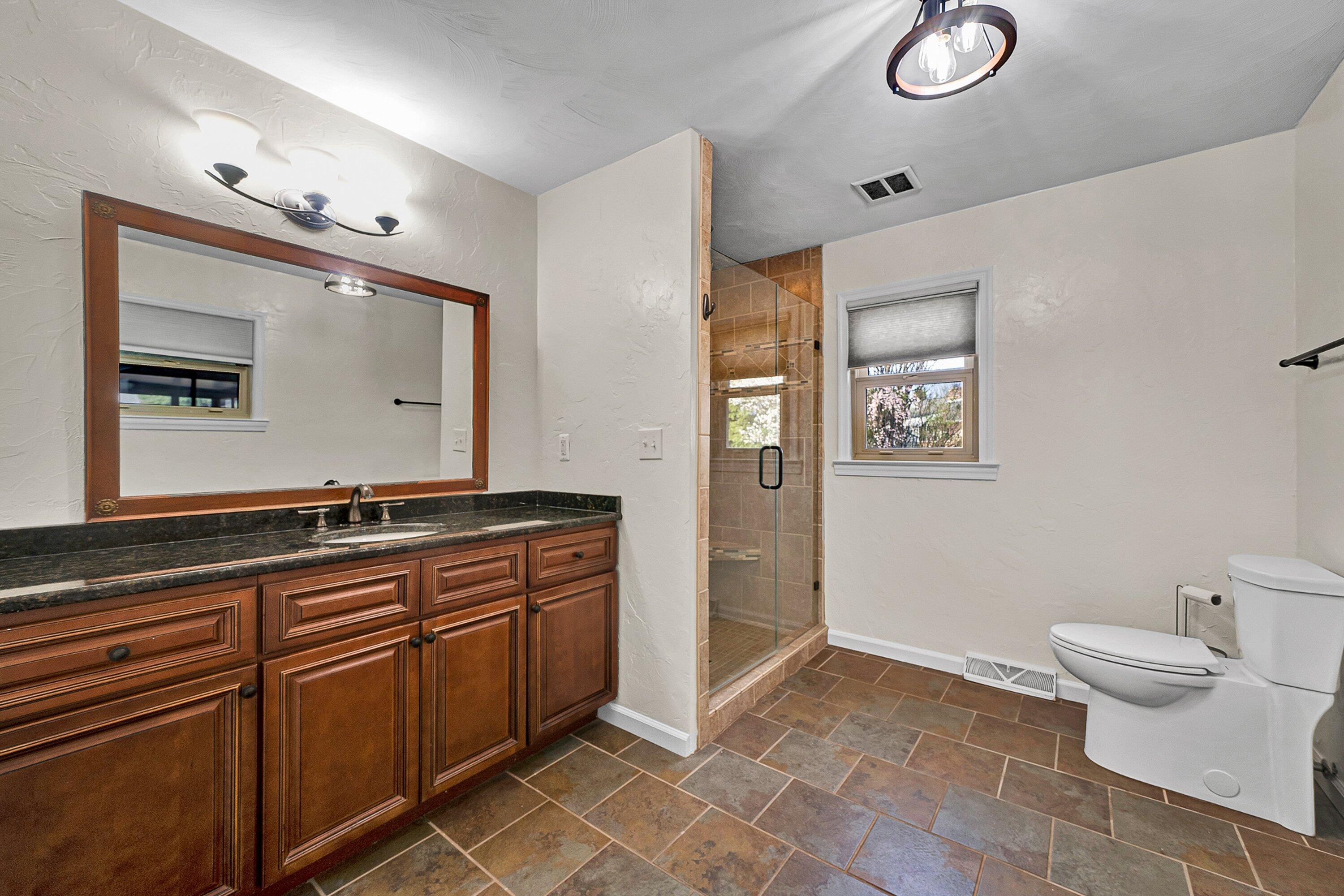 405 Diamond Road Salem, VA 24153 - Photo 15 of 28 a spacious bathroom with a double vanity sink a toilet and a mirror