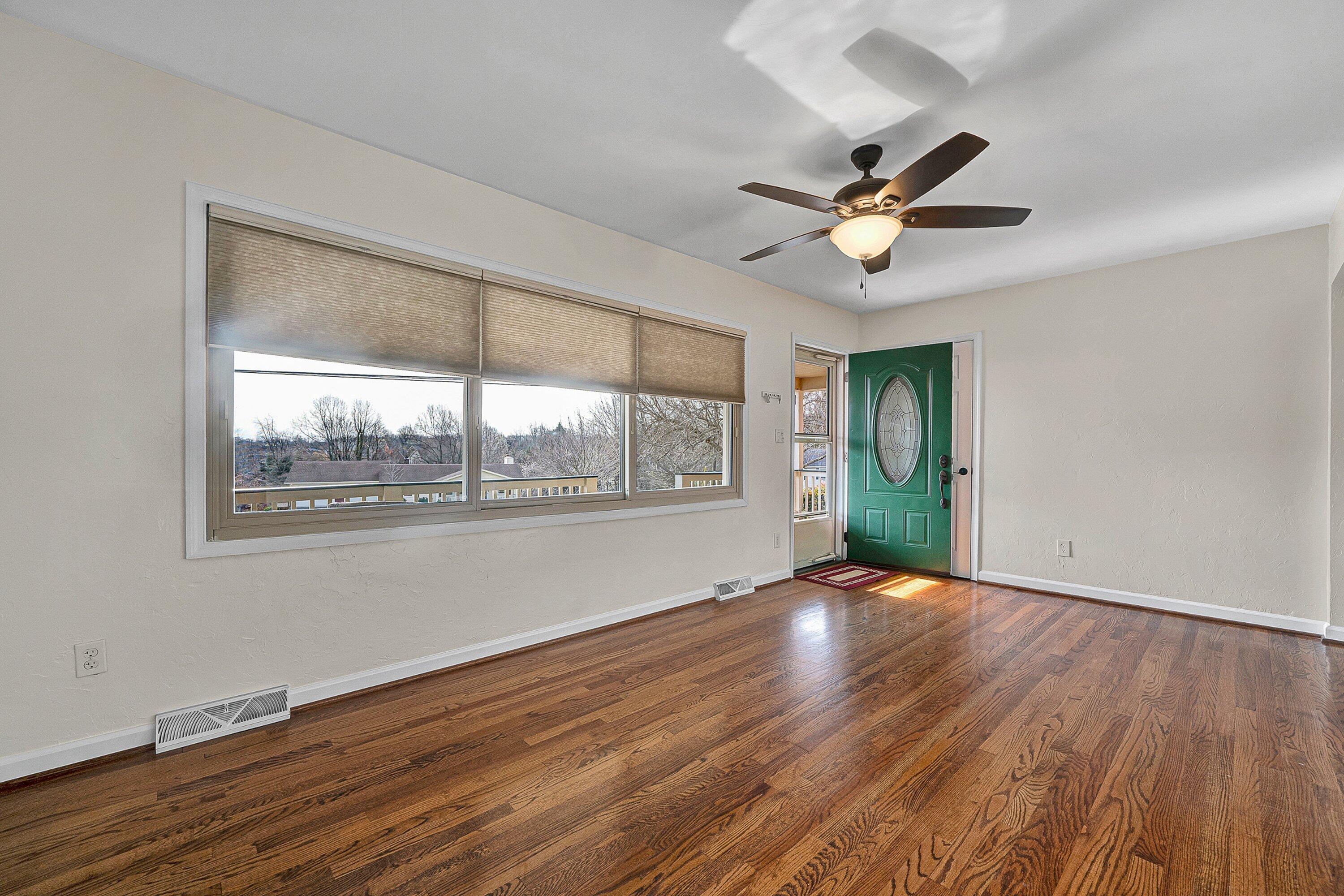 405 Diamond Road Salem, VA 24153 - Photo 4 of 28 a view of an empty room with wooden floor and a window