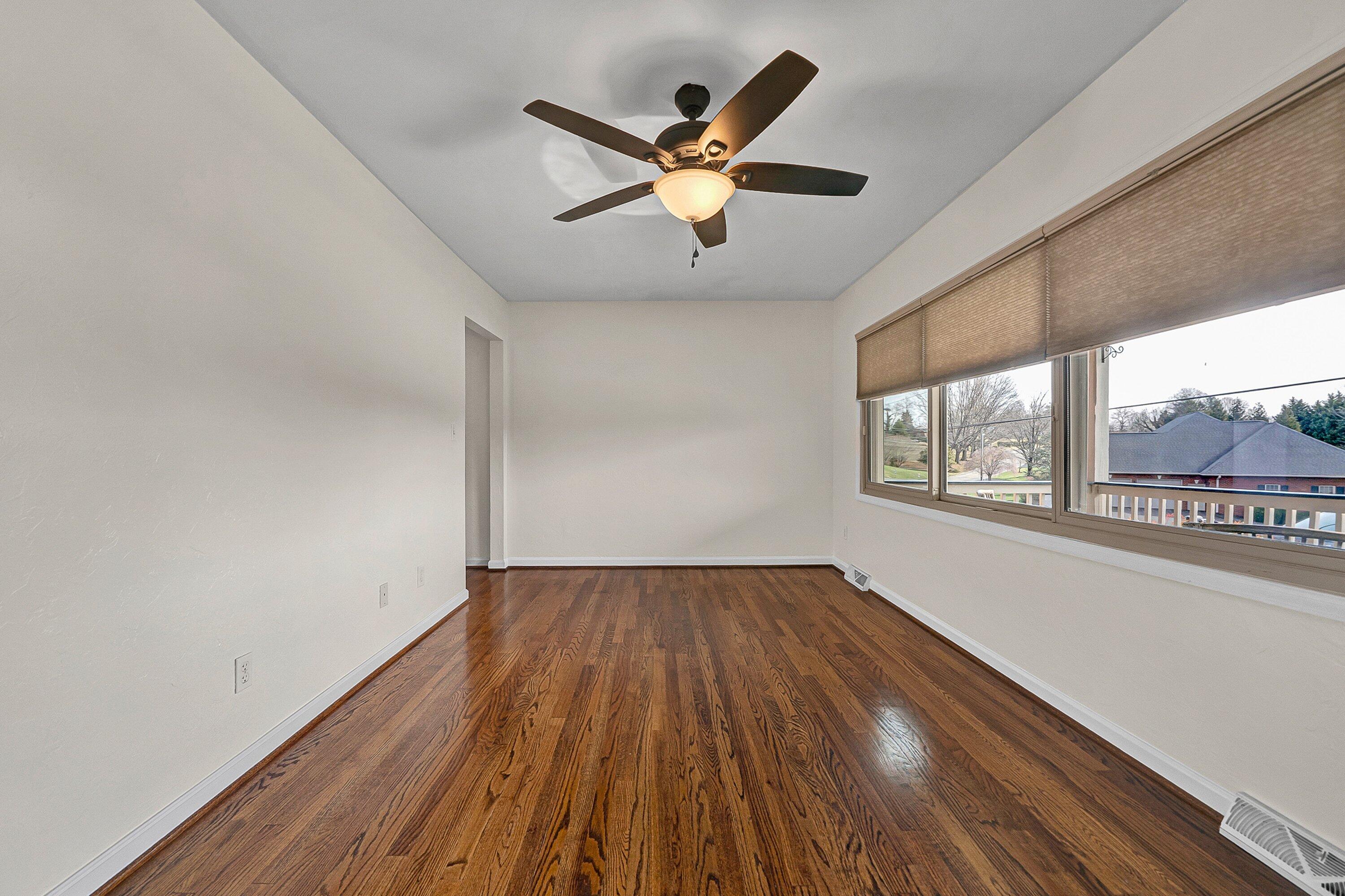 405 Diamond Road Salem, VA 24153 - Photo 5 of 28 wooden floor in an empty room with a window