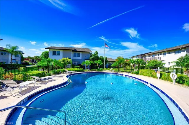 a view of swimming pool with outdoor seating and plants