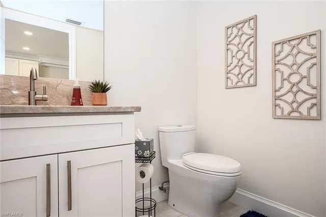 a white toilet sitting next to a bathroom sink