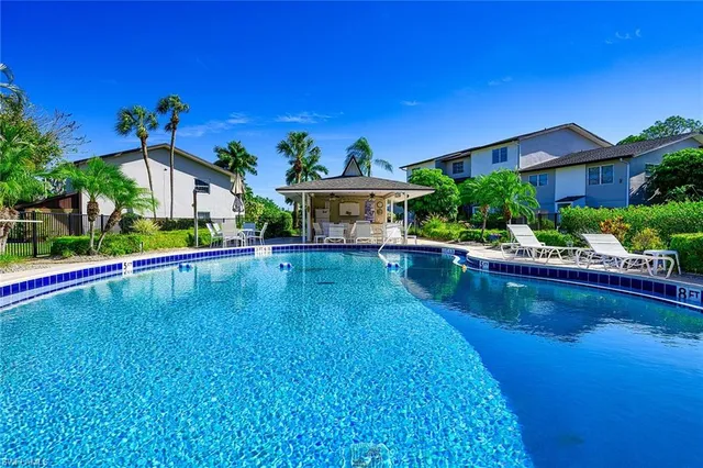 a view of a house with pool yard and outdoor seating
