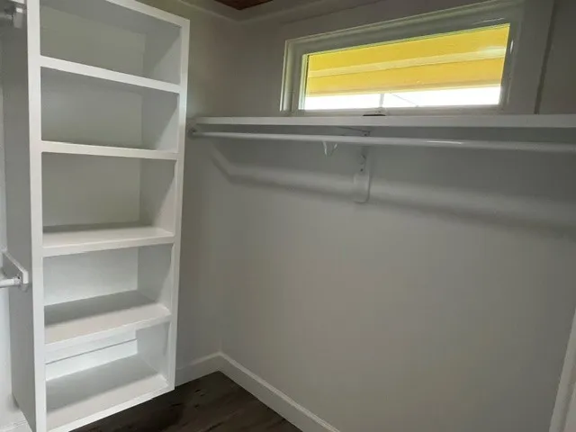 a view of walk in closet with empty racks