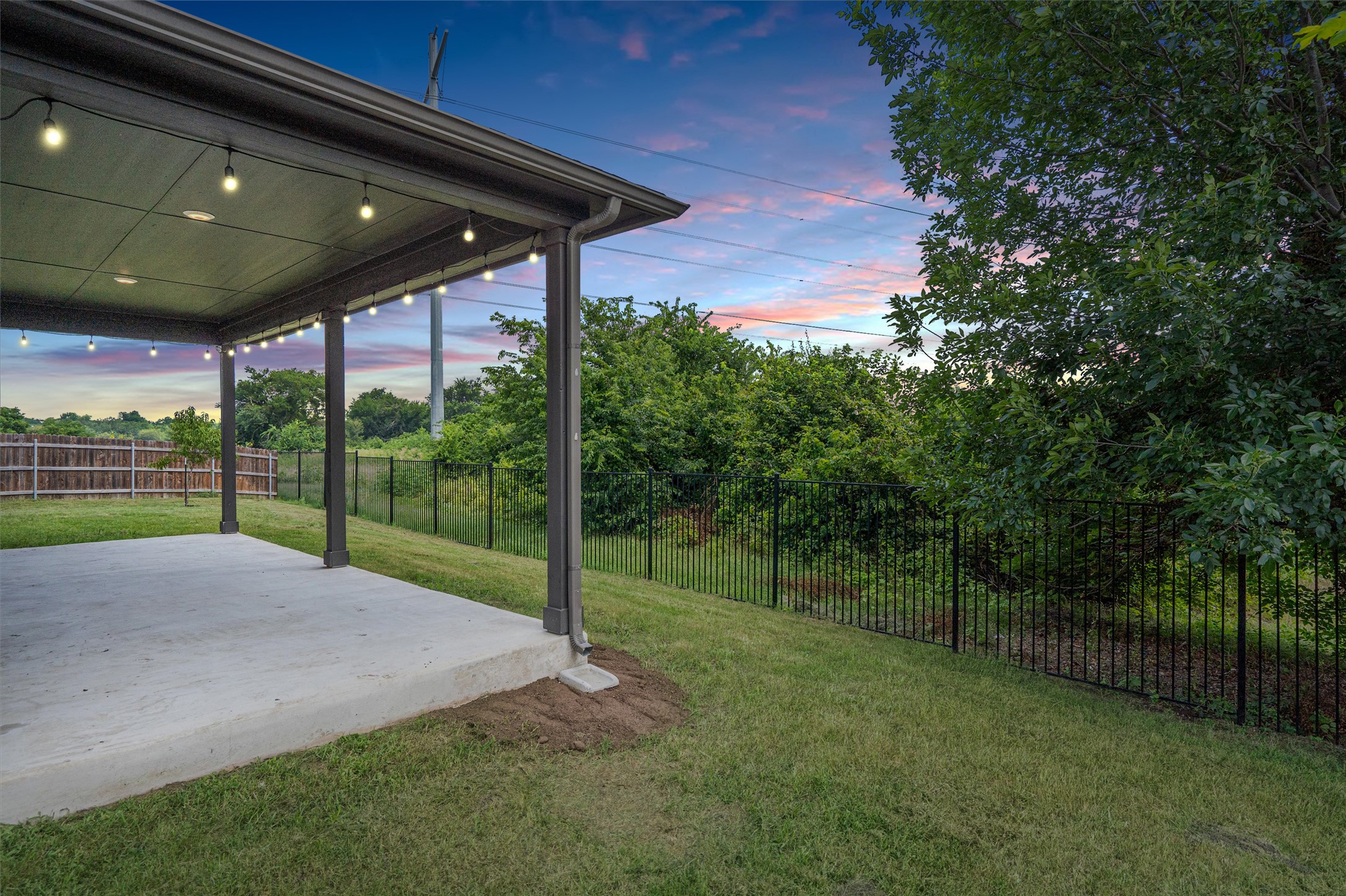 104 Stinchcomb Road Hutto, TX 78634 - Photo 30 of 40 Step outside to enjoy a large covered patio, fruit trees, an oversized backyard, and a peaceful greenbelt backdrop that makes the outdoor space feel both private and rare.