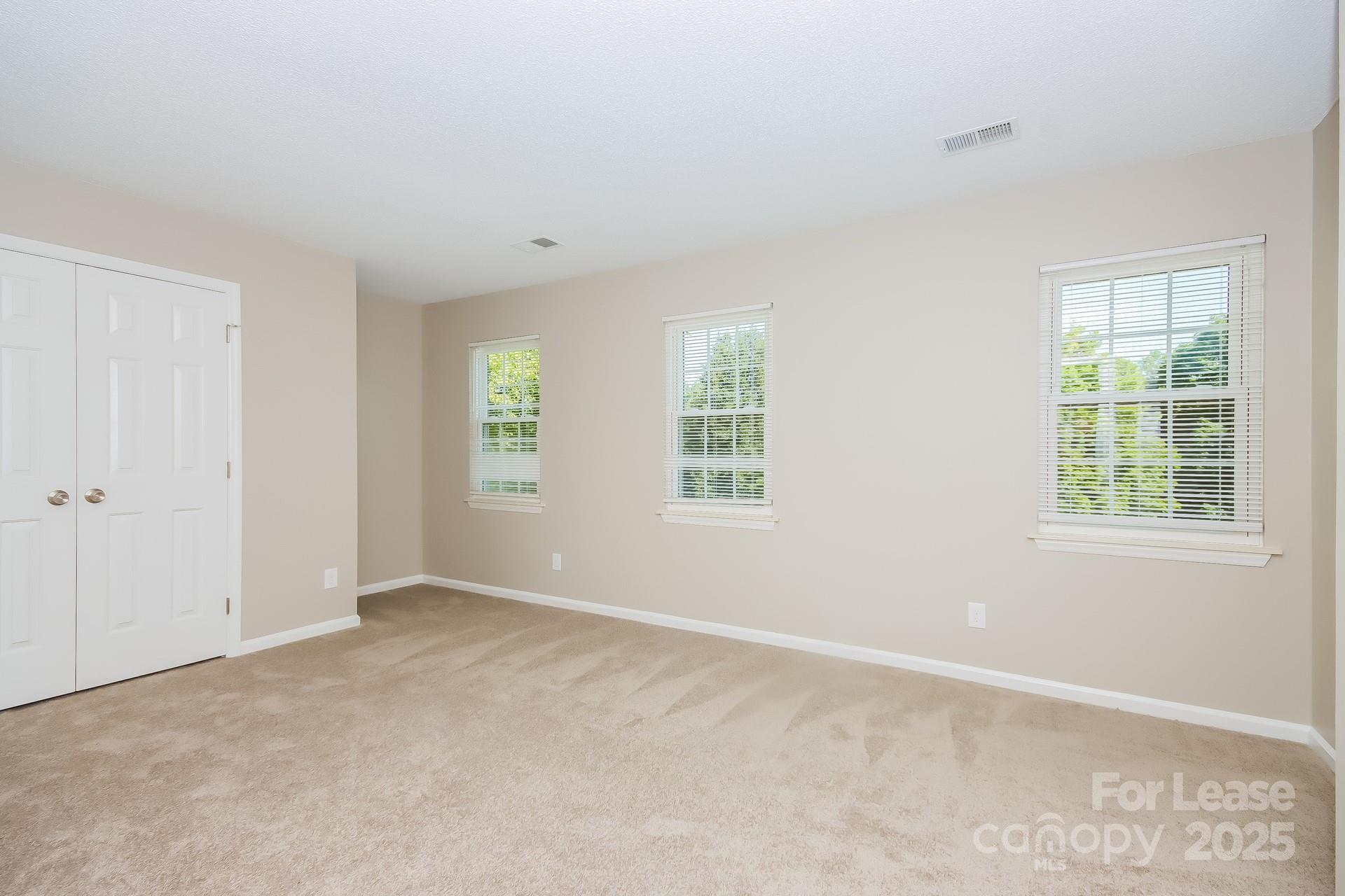 9216 Torrence Crossing Drive Huntersville, NC 28078 - Photo 12 of 17 an empty room with windows