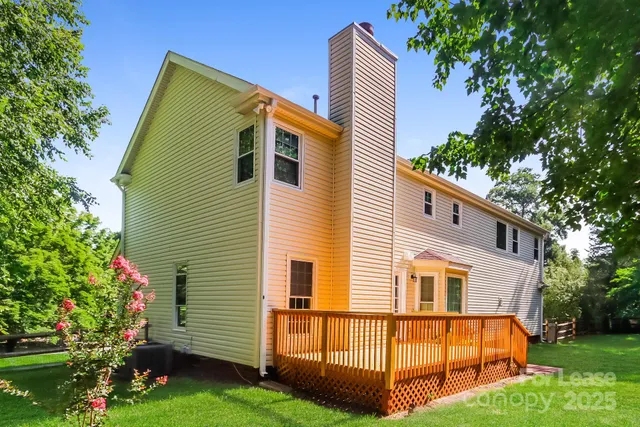 a view of backyard with a garden and deck