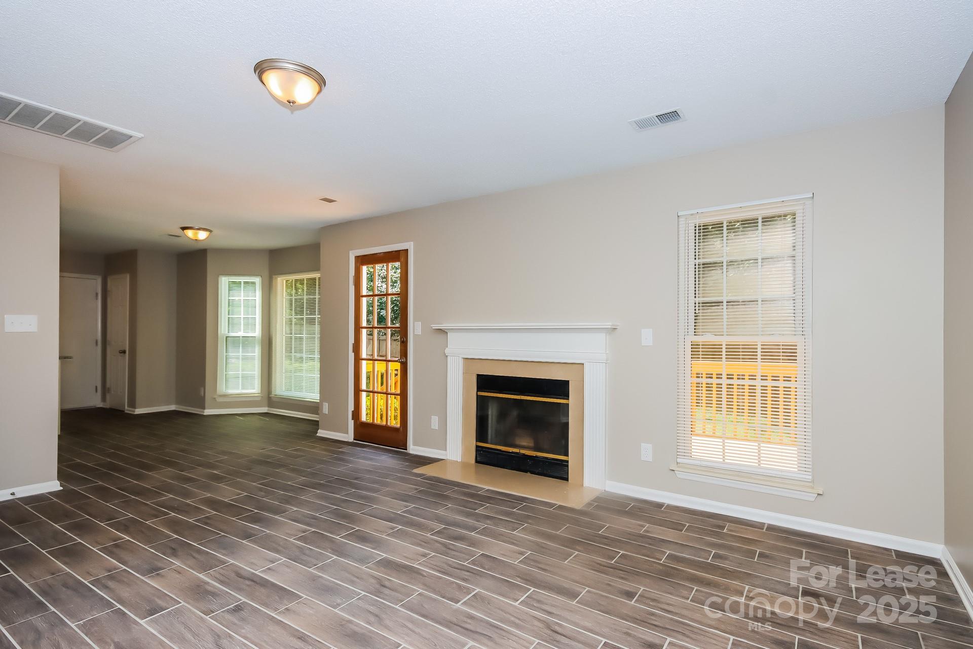 9216 Torrence Crossing Drive Huntersville, NC 28078 - Photo 4 of 17 a view of an empty room with window and fire place