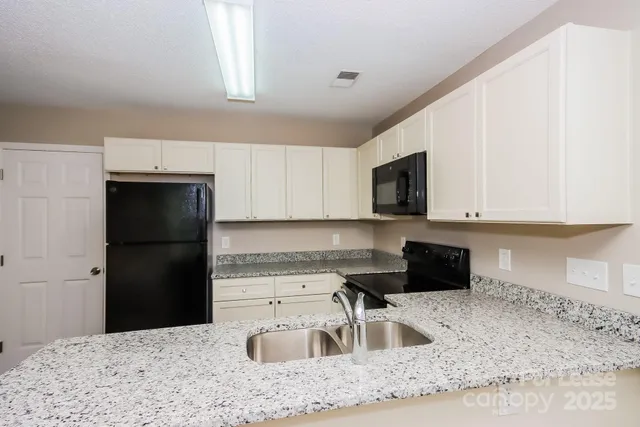 a kitchen with a refrigerator stove and sink