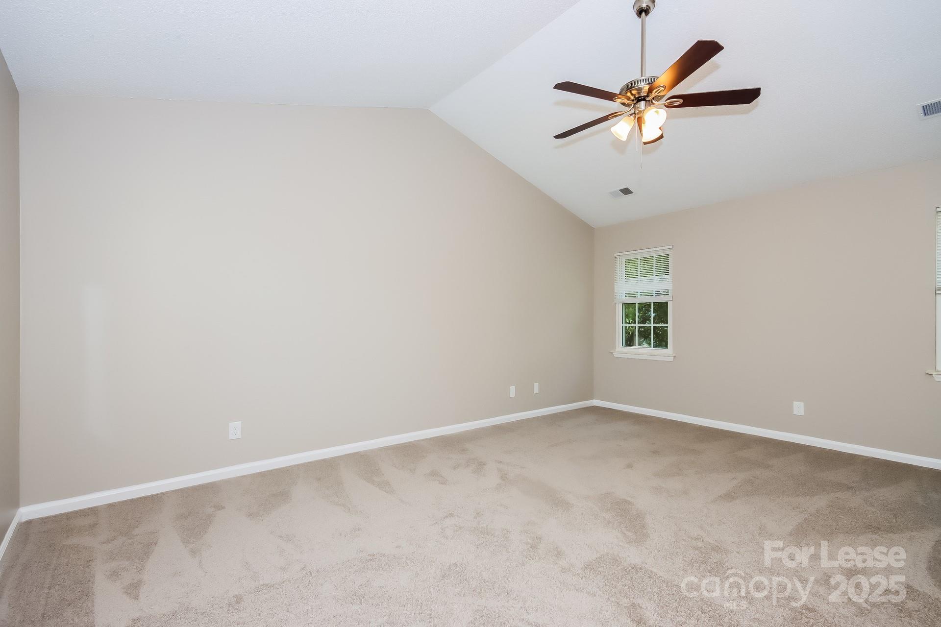9216 Torrence Crossing Drive Huntersville, NC 28078 - Photo 10 of 17 an empty room with a window and a fan