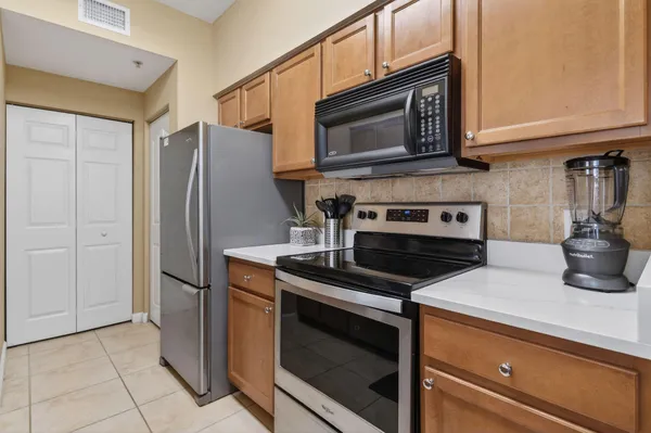 a kitchen with granite countertop cabinets and steel stainless steel appliances
