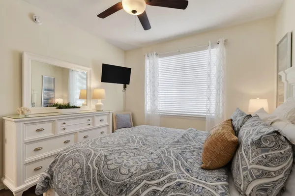 a bedroom with a large bed and a flat screen tv