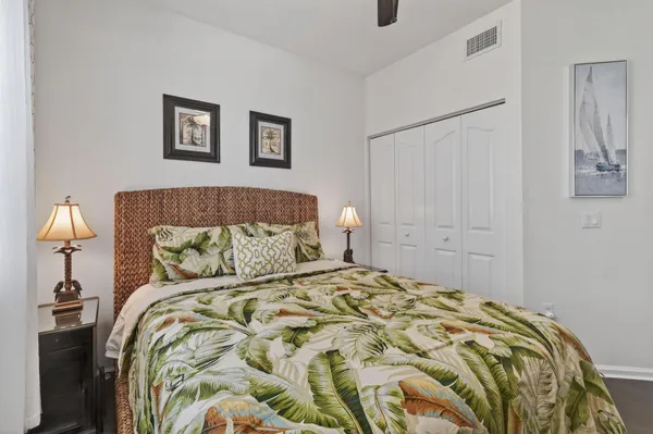 a bedroom with a bed and a night stand