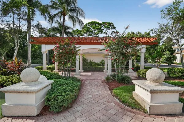 a view of a chair and tables in the patio in front of a house