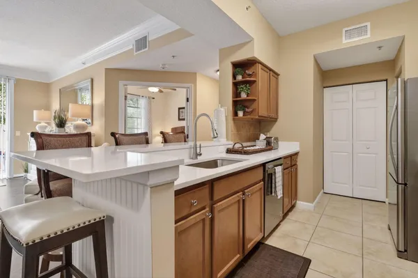 a kitchen with a sink cabinets and refrigerator