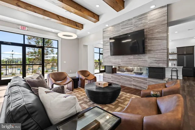 a living room with furniture fireplace and flat screen tv