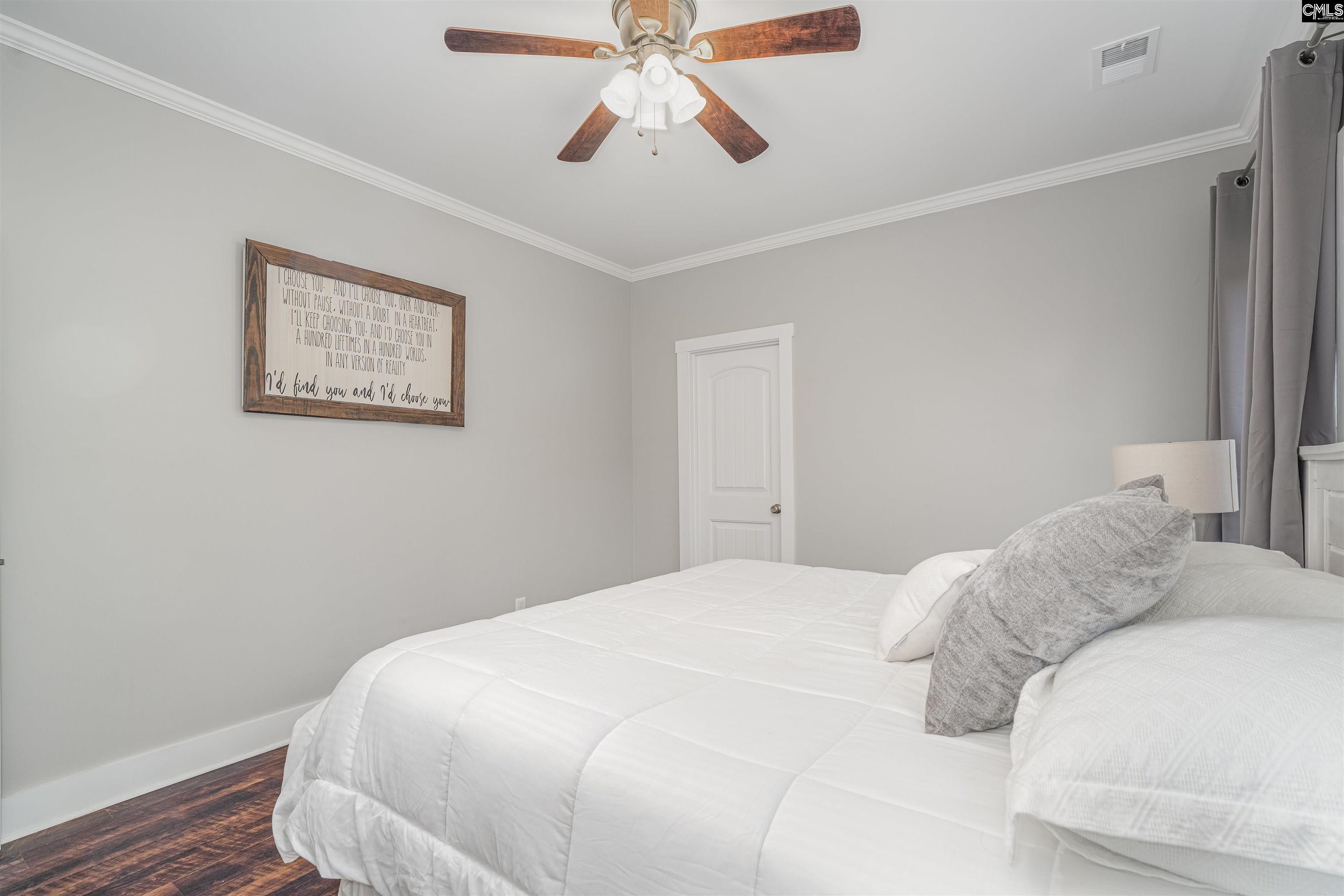 649 Sandbar Road Chapin, SC 29036 - Photo 21 of 40 a bedroom with a bed and a chandelier