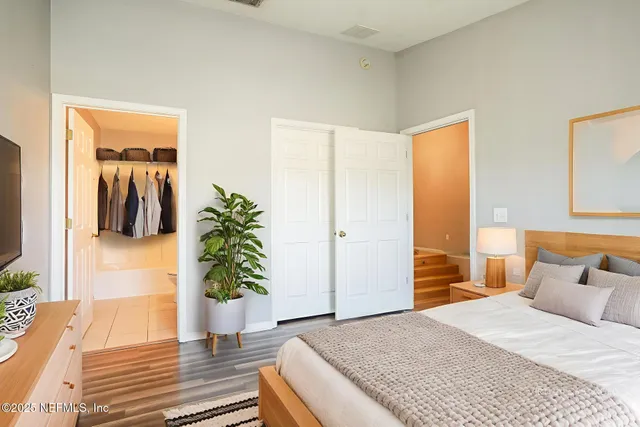 a bedroom with a bed and a potted plant