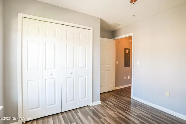 a view of a room with wooden floor