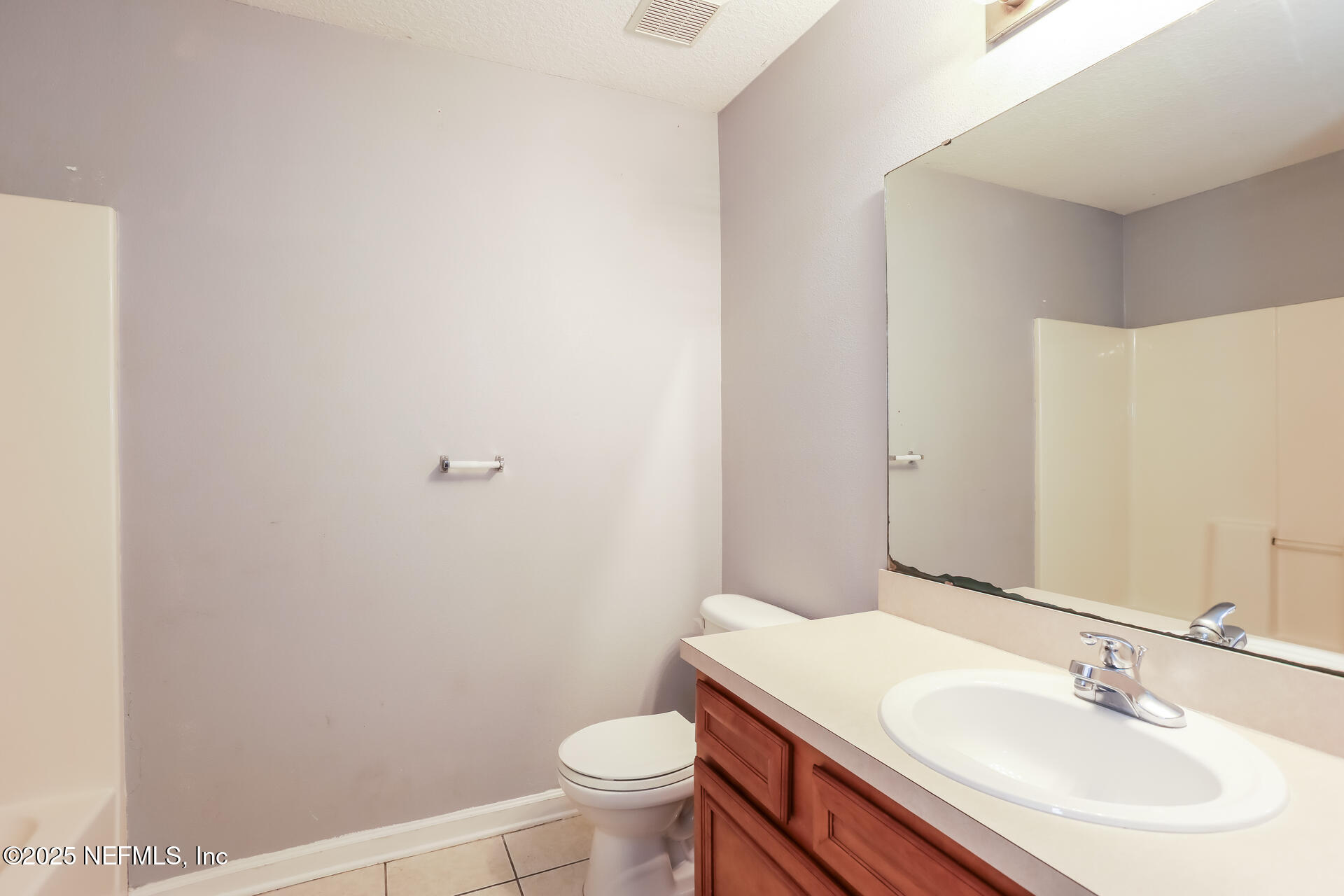 6860 Skaff Avenue, Unit 29 Jacksonville, FL 32244 - Photo 15 of 18 a bathroom with a sink toilet and vanity