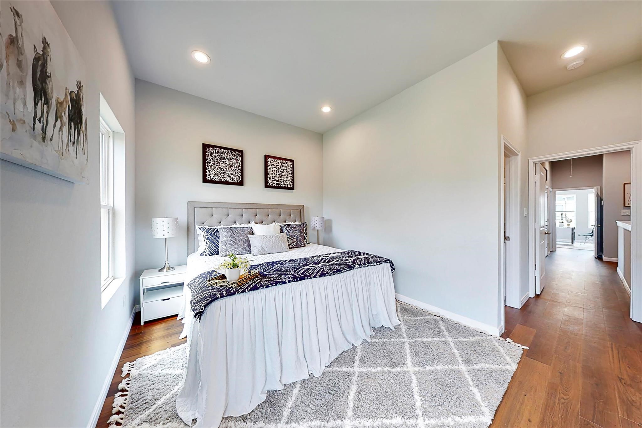 18813 Luminescent Lane Spring, TX 77379 - Photo 13 of 19 a bedroom with a bed and a wooden floor