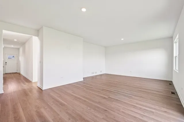 a view of a kitchen with a microwave and wooden floor