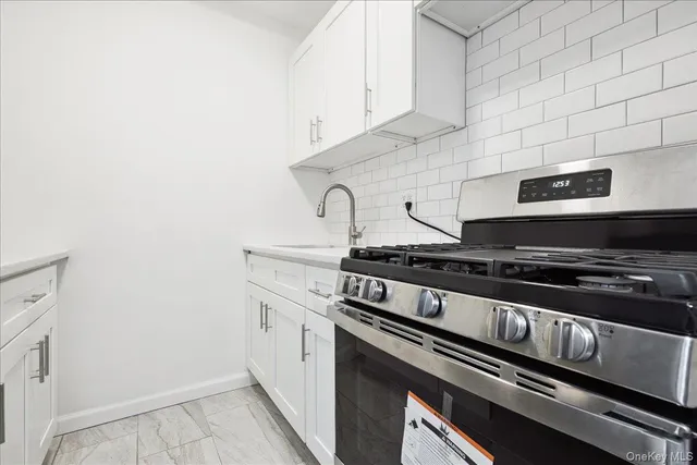 a kitchen with granite countertop a stove and a sink