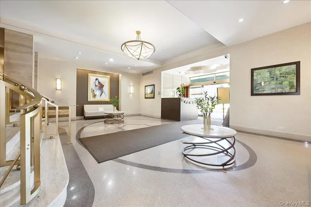 a view of a lobby with furniture and a chandelier
