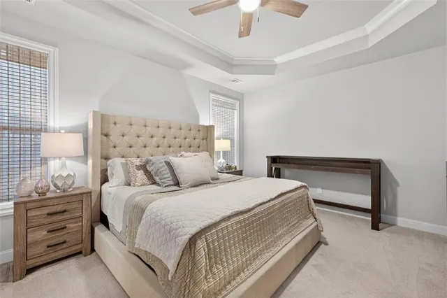a bedroom with a bed and a ceiling fan