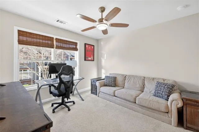 a work room with furniture and a large window