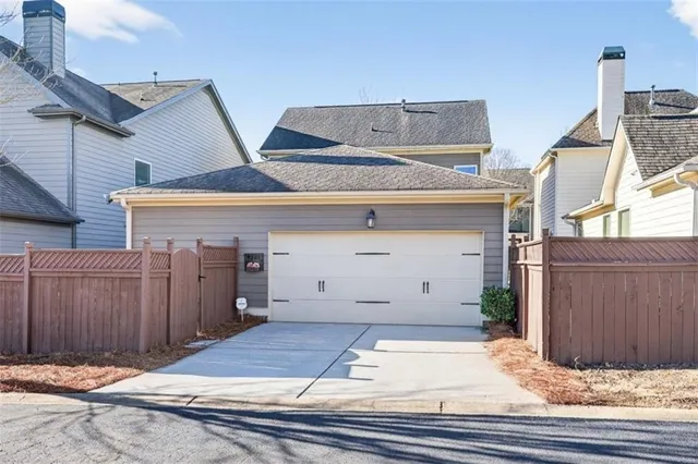 a view of a brick house with wooden fence