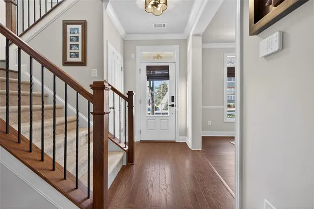 a view of an entryway with wooden floor