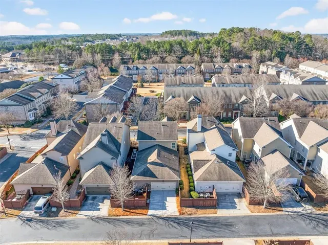 an aerial view of residential houses with outdoor space
