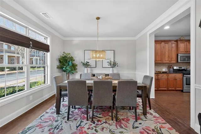 a dining room with furniture wooden floor and a rug