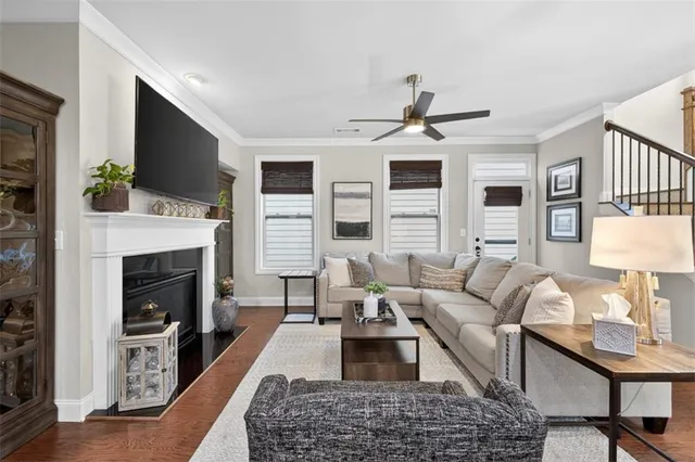 a living room with furniture a flat screen tv and a fireplace