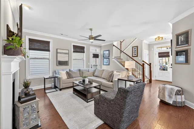 a living room with furniture and wooden floor